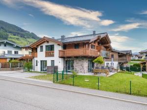 a house with a fence on the side of a street at Bergbiberhaus L in Piesendorf