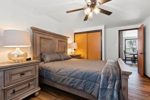 a bedroom with a bed and a ceiling fan at Three Bedroom Ranch walking distance to Lambeau in Green Bay