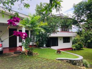 a house with a hose in front of a yard at Galle Rest Home in Galle