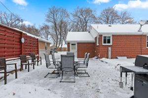 a patio with a table and chairs in the snow at Three Bedroom Ranch walking distance to Lambeau in Green Bay