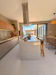 a kitchen with a island in the middle of a room at Casa Don Magalhães in Barra de São Miguel