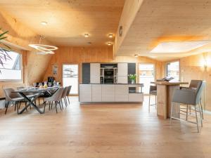 a kitchen and dining room with a table and chairs at Panorama Loft in Wörgl