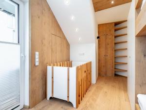a room with a staircase and wooden walls at Panorama Loft in Wörgl