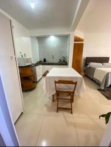 a room with a bed and a table with a chair at Hospedaria Klagemberg in Treze Tílias