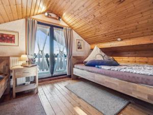 a bedroom with a bed and a large window at Das Haus am Wald in Waltershausen
