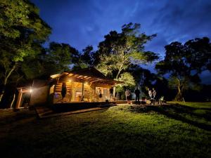 a group of people standing outside of a tiny house at Morada da Mata in Candelária