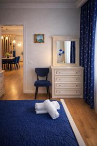 a bedroom with a blue bed and a blue chair at Chill House in Kutaisi