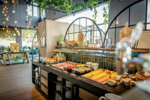 a buffet line with food on display in a restaurant at Motel One Wiesbaden in Wiesbaden