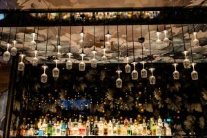 a bunch of lights hanging over a bar with bottles at Motel One Wiesbaden in Wiesbaden