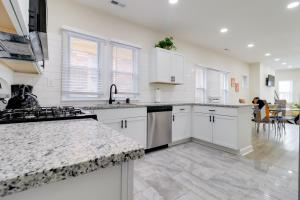a kitchen with white cabinets and a counter top at Modern Updates & Great Location! Detroit Duplex in Detroit