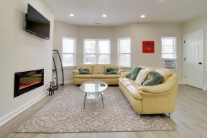 a living room with two couches and a fireplace at Modern Updates & Great Location! Detroit Duplex in Detroit