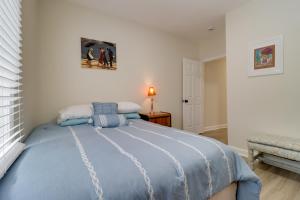 a bedroom with a bed with a blue comforter at Modern Updates & Great Location! Detroit Duplex in Detroit