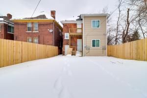a pile of snow in front of a fence at Modern Updates & Great Location! Detroit Duplex in Detroit