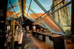 a restaurant with a long bar in a building at Motel One Ulm in Ulm +35 photos