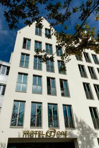 a white building with a sign on it at Motel One Ulm in Ulm