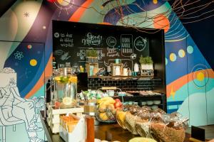a bakery with a display of food on a table at Motel One Ulm in Ulm