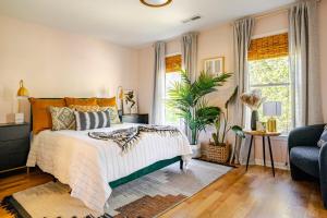 a bedroom with a bed and a potted plant at Lush, Spacious Intown Retreat in Atlanta