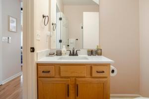 a bathroom with a sink and a mirror at Lush, Spacious Intown Retreat in Atlanta +44 photos