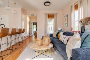 a living room with a blue couch and a table at Lush, Spacious Intown Retreat in Atlanta