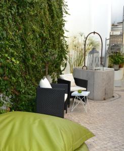 
a living room filled with furniture and plants at Tavira House in Tavira
