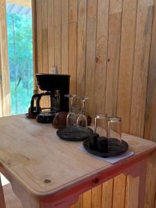 a wooden table with plates and glasses on it at Cabaña en el Rancho in San Jose del Pacifico