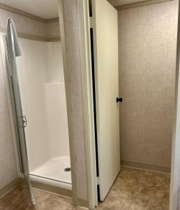a bathroom with a shower and a tub at Mountainside Inn 115 by Alpine Lodging Telluride in Telluride