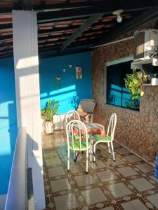 a dining room with a table and chairs on a tile floor at Brisa Tropical in Ilhéus