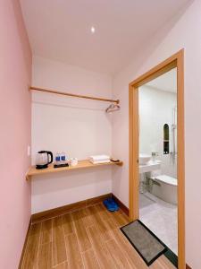a bathroom with a counter and a sink and a mirror at DEE Homestay in Hue