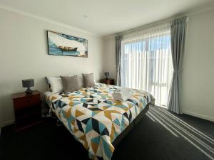 a bedroom with a bed and a large window at Star View in Lake Tekapo