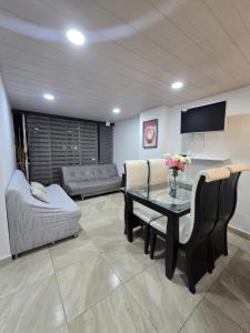 a living room with a table and a couch at Penthouse Barú - Usaquén in Bogotá