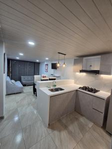 a kitchen with a sink and a stove in a room at Penthouse Barú - Usaquén in Bogotá