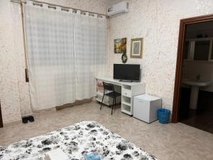a bedroom with a desk with a computer on it at Bianca B&B in Ardea