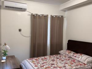 a bedroom with a bed and a window with a heater at The Infinity View in Talisay +27 photos