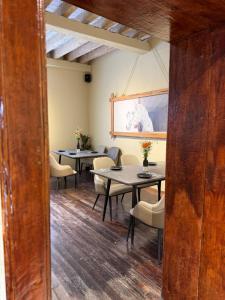 a dining room with tables and chairs and a painting at Casa Bravo in Toluca
