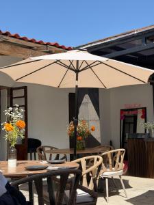 a table and chairs with an umbrella on a patio at Casa Bravo in Toluca
