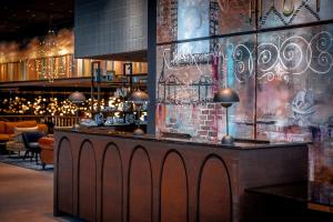 a bar in a restaurant with a brick wall at The Cloud One Hamburg-Kontorhaus in Hamburg