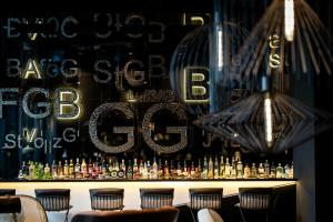 a bar with a display of bottles of alcohol at Motel One Karlsruhe in Karlsruhe