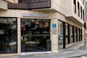 a store front of a building with glass windows at Motel One Madrid-Plaza de España in Madrid