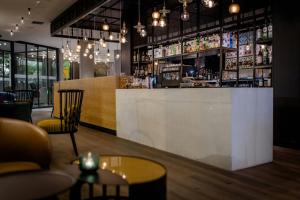 a bar in a restaurant with chairs and tables at Motel One Madrid-Plaza de España in Madrid +38 photos