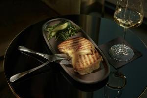 a plate with a sandwich and a fork on a table at The Cloud One Prague in Prague