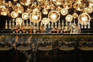 a bar with a bunch of bottles of wine at The Cloud One Gdansk in Gdańsk