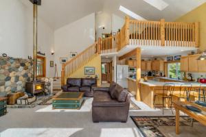 a large living room with a staircase and a living room at Pine Tree Cottage by NW Comfy Cabins in Leavenworth