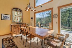 a dining room with a wooden table and chairs at Pine Tree Cottage by NW Comfy Cabins in Leavenworth