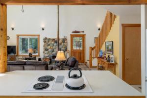 a tea kettle on a stove in a living room at Pine Tree Cottage by NW Comfy Cabins in Leavenworth