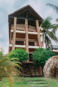 a building with palm trees in front of it at Casa triplex Lagoinha in Lagoinha