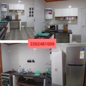 a kitchen with white cabinets and a red sign on it at Cabaña in Necochea