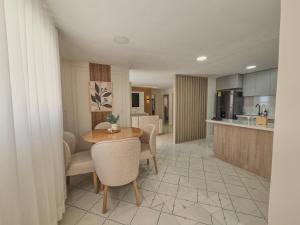 a kitchen and living room with a table and chairs at Margarita 93 in Barranquilla