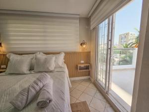 a bedroom with a bed and a large window at Margarita 93 in Barranquilla
