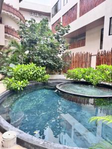 a swimming pool in the middle of a building at Xiib Kaab Estudio con Jacuzzi in Tulum