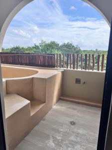 an arched window in a room with a view at Xiib Kaab Estudio con Jacuzzi in Tulum